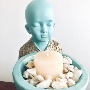 Monje con vela y piedras de cuarzo
